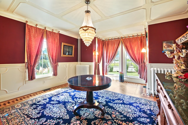 living area featuring radiator, an inviting chandelier, and ornamental molding