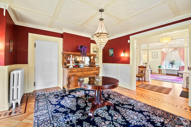 interior space with crown molding, radiator heating unit, and a notable chandelier