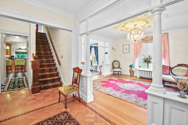 foyer featuring parquet floors, ornamental molding, an inviting chandelier, and a wealth of natural light