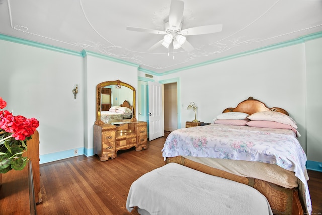 bedroom featuring crown molding, ceiling fan, and hardwood / wood-style flooring