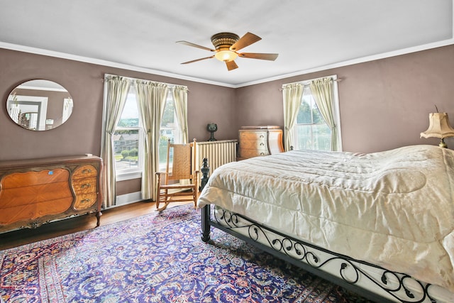 bedroom featuring multiple windows, ornamental molding, and ceiling fan