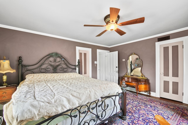 bedroom featuring ceiling fan, hardwood / wood-style floors, and ornamental molding