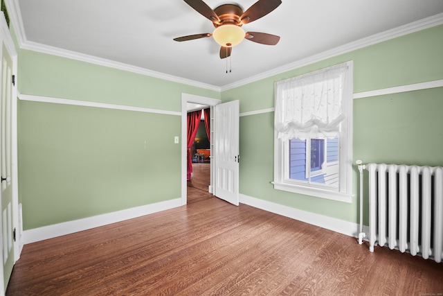 unfurnished bedroom featuring crown molding, radiator, hardwood / wood-style floors, and ceiling fan