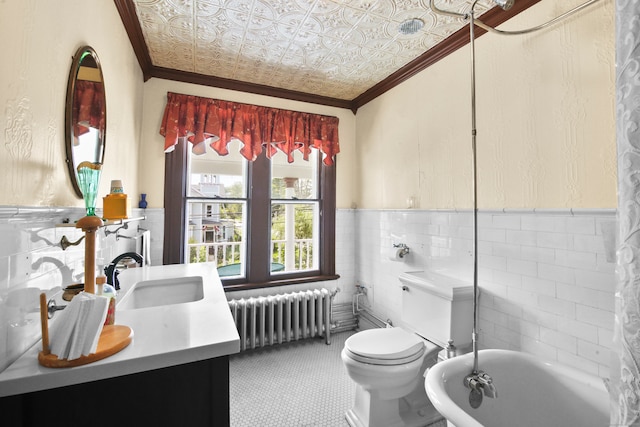 bathroom featuring tile walls, vanity, radiator, a tub, and toilet