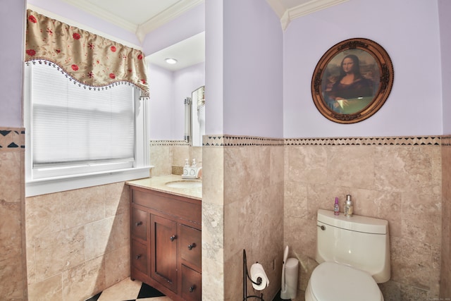 bathroom featuring tile walls, vanity, toilet, and ornamental molding