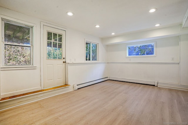 interior space with baseboard heating and light wood-type flooring