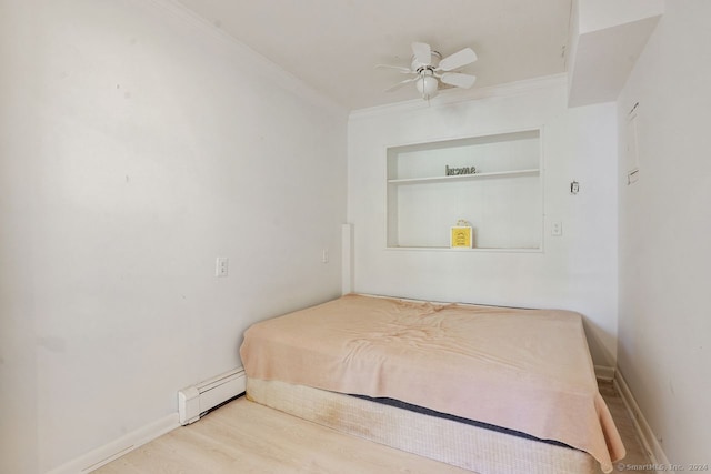 bedroom with ceiling fan, baseboard heating, hardwood / wood-style flooring, and ornamental molding