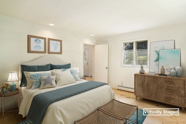 bedroom featuring light wood-type flooring and baseboard heating