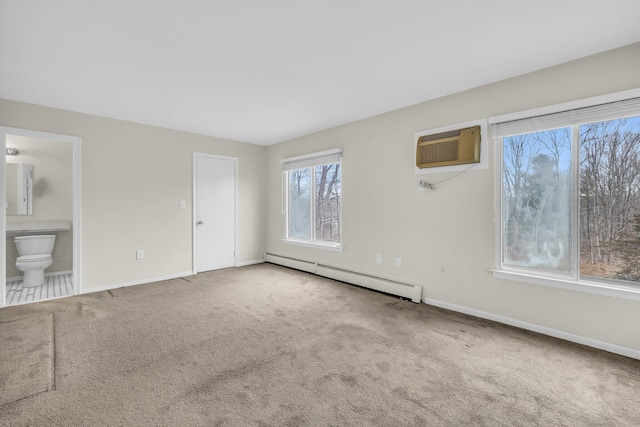 carpeted empty room featuring a wall mounted AC and baseboard heating