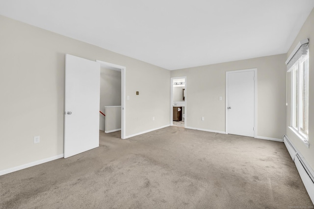 unfurnished room featuring a baseboard radiator and light carpet