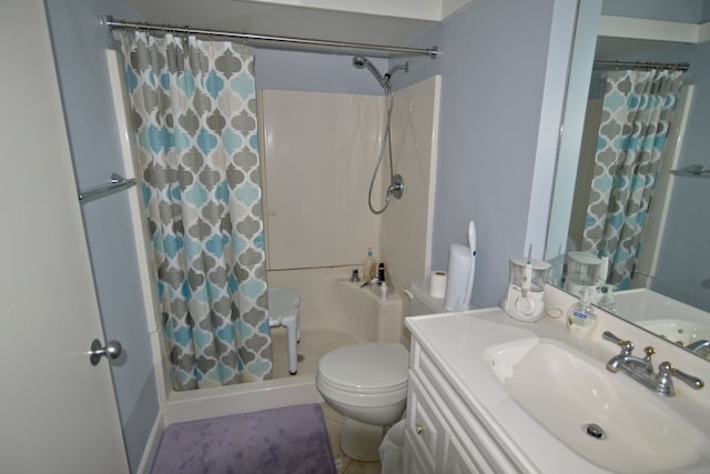 bathroom featuring tile patterned flooring, a shower with curtain, vanity, and toilet