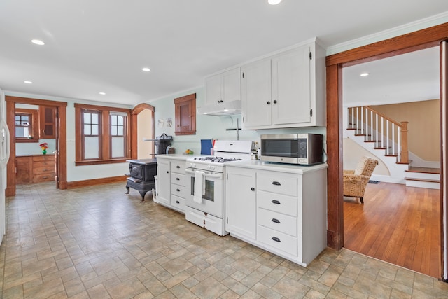 kitchen featuring light hardwood / wood-style flooring, white cabinetry, and white gas range oven