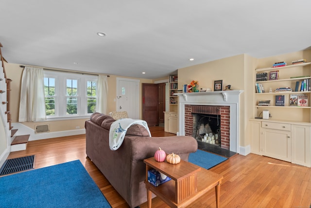 living room featuring light hardwood / wood-style flooring and a fireplace