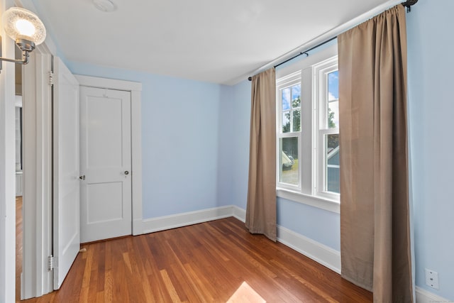 unfurnished bedroom featuring hardwood / wood-style flooring