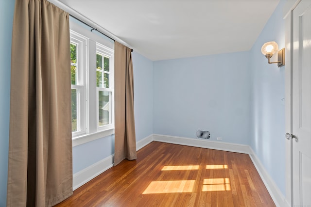 empty room with hardwood / wood-style flooring