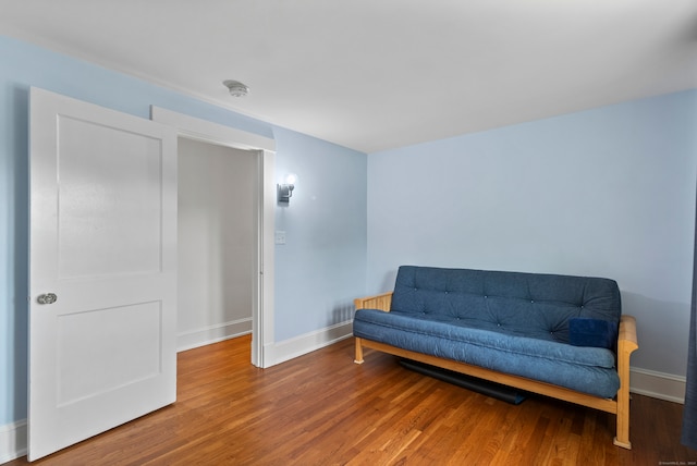 sitting room with wood-type flooring