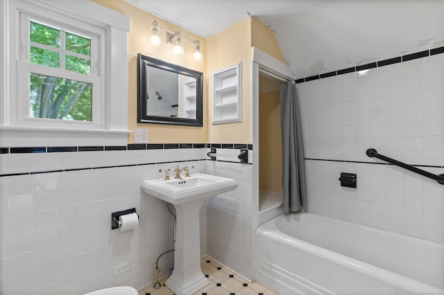 bathroom with tile walls and toilet