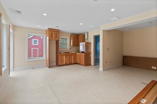 unfurnished living room featuring light colored carpet