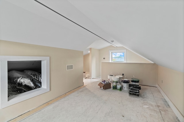 additional living space featuring vaulted ceiling