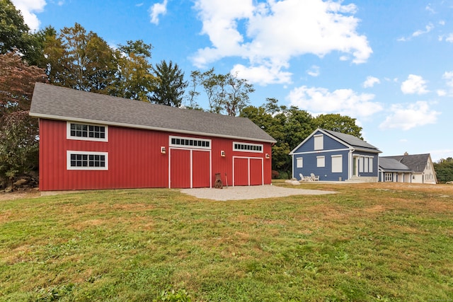 view of outbuilding featuring a lawn