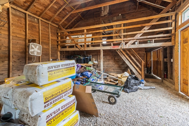 miscellaneous room with carpet floors, wooden walls, and lofted ceiling