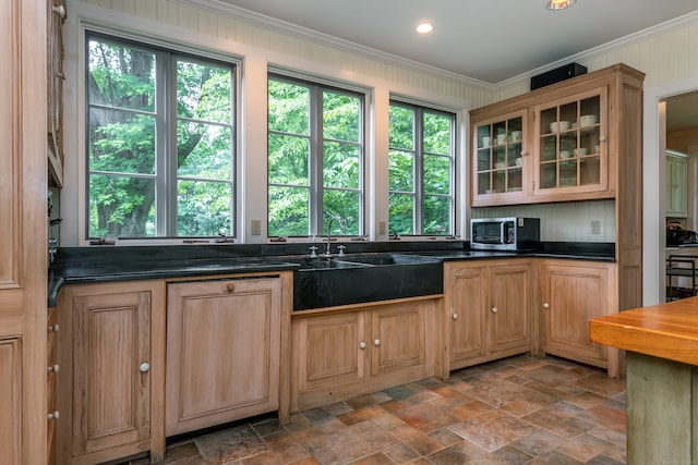 kitchen featuring wooden walls and ornamental molding