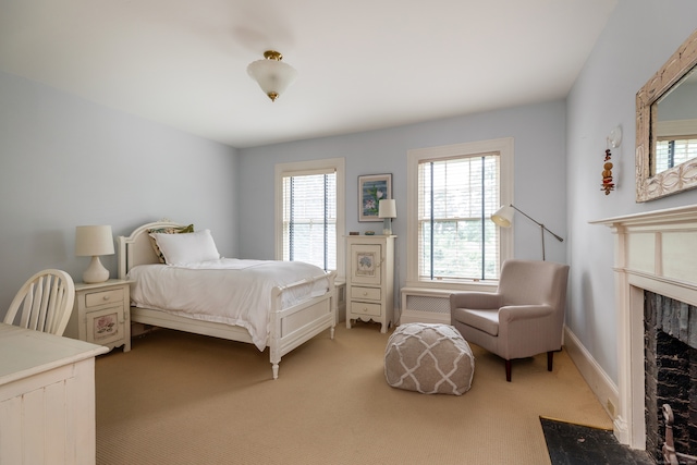 bedroom featuring carpet floors and a premium fireplace