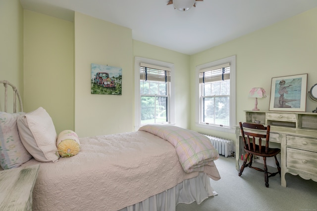 bedroom with light carpet and radiator