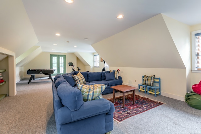 carpeted living room with french doors and lofted ceiling