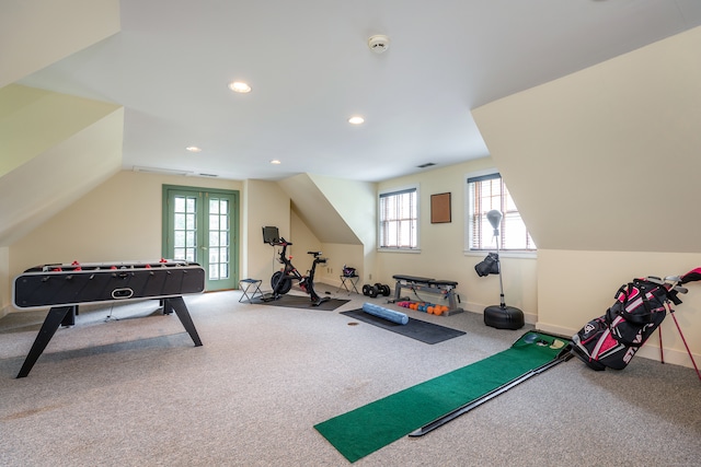 workout area featuring french doors, vaulted ceiling, and carpet flooring