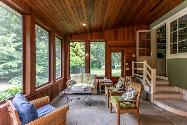 sunroom / solarium with wood ceiling, plenty of natural light, and vaulted ceiling