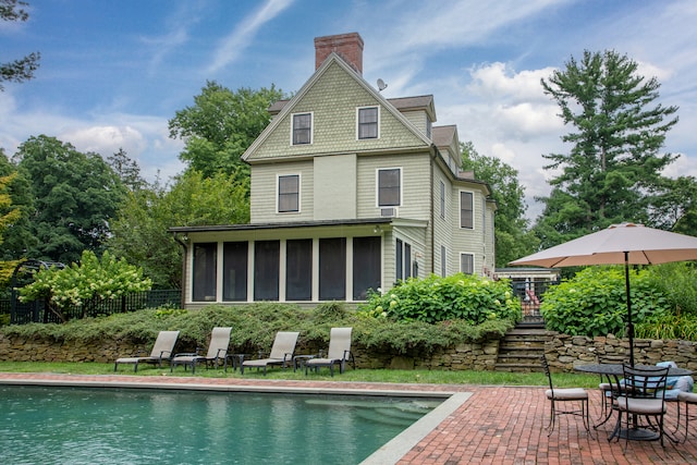 back of house featuring a patio and a sunroom