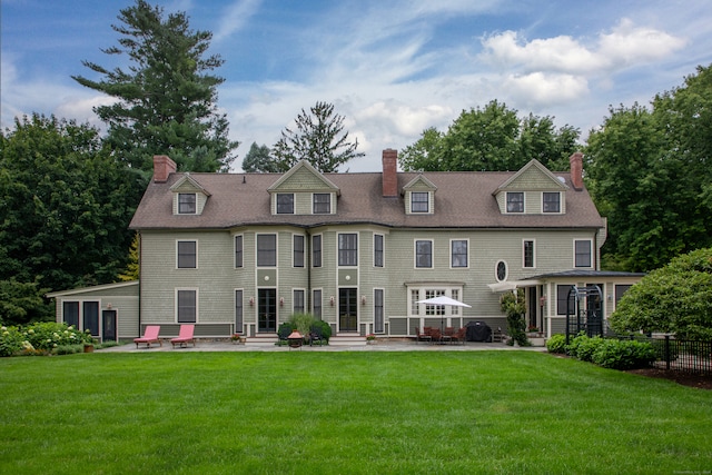 back of property featuring a yard and a patio area