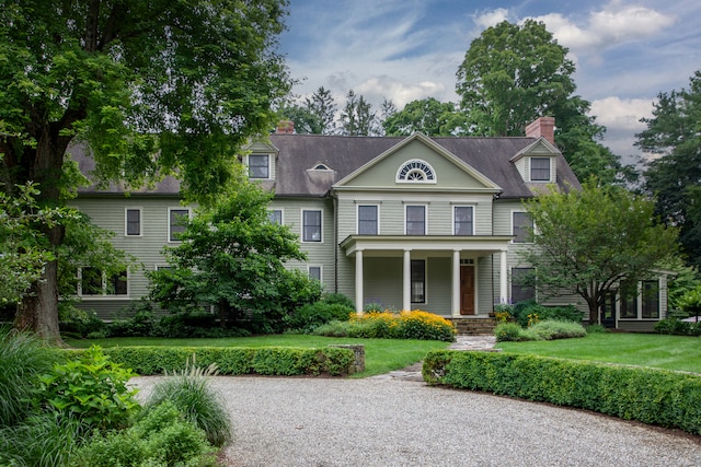 view of front of house with covered porch and a front yard