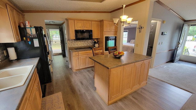 1 Circle Dr, Windham, CT 06256 - kitchen with lofted ceiling, an inviting chandelier, a sink, crown molding, and black appliances