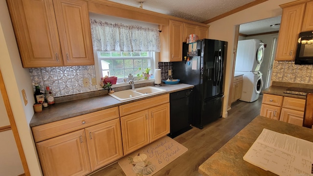1 Circle Dr, Windham, CT 06256 - kitchen with stacked washer and clothes dryer, a sink, black appliances, backsplash, and ornamental molding