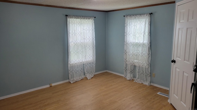 1 Circle Dr, Windham, CT 06256 - spare room with a textured ceiling, a wealth of natural light, light wood-style flooring, and visible vents