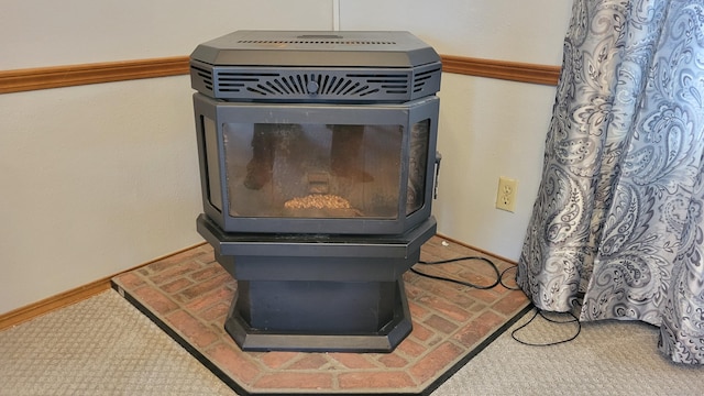 1 Circle Dr, Windham, CT 06256 - interior details featuring a wood stove and baseboards