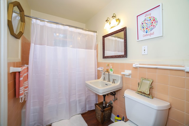 bathroom featuring sink, tile walls, hardwood / wood-style floors, and toilet