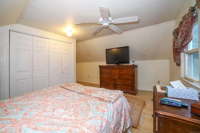 bedroom featuring light hardwood / wood-style flooring, a closet, vaulted ceiling, and ceiling fan