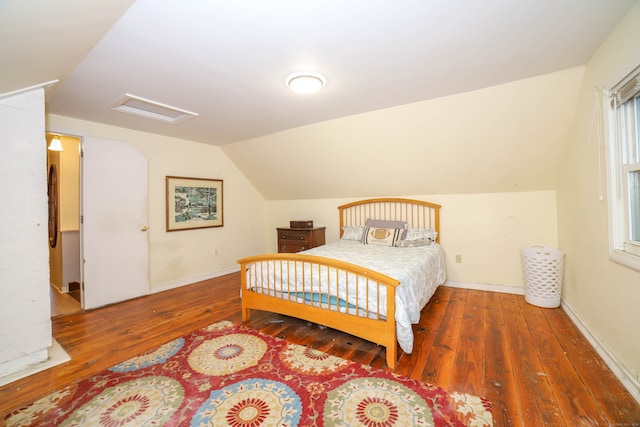 bedroom with vaulted ceiling and dark hardwood / wood-style floors