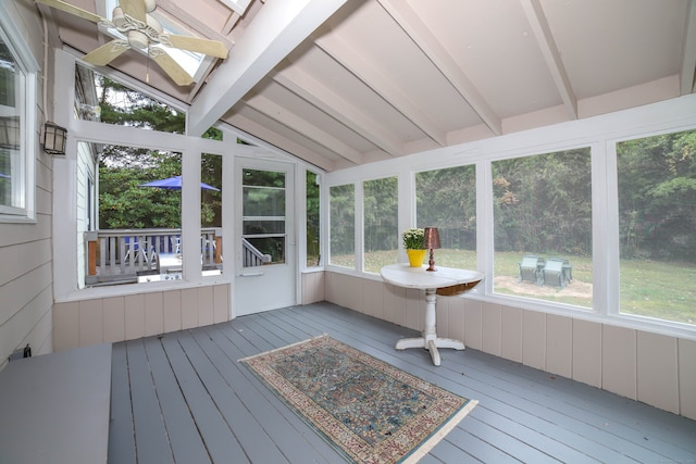 unfurnished sunroom featuring vaulted ceiling with beams and ceiling fan