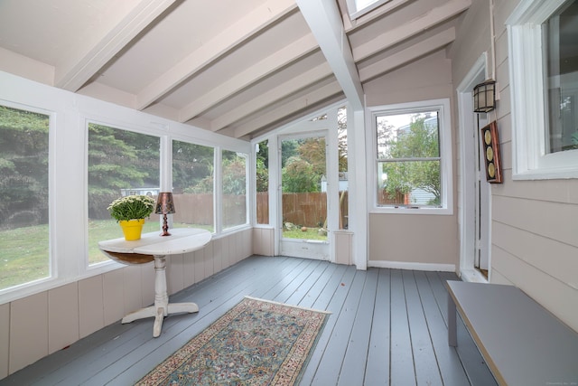 sunroom / solarium with vaulted ceiling with skylight and a wealth of natural light