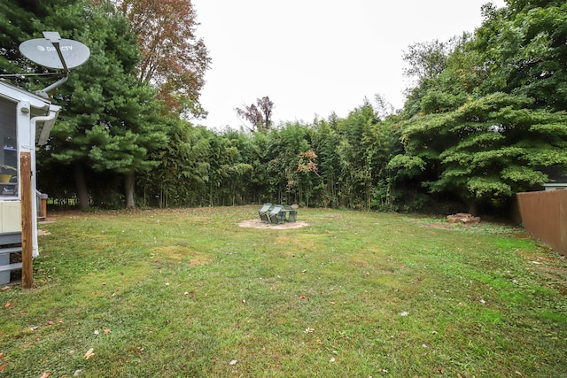 view of yard with a fire pit