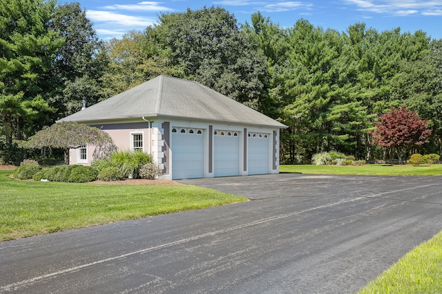 view of property exterior with a yard and a garage