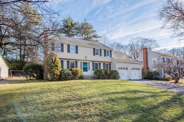 view of front of house with a garage and a front lawn