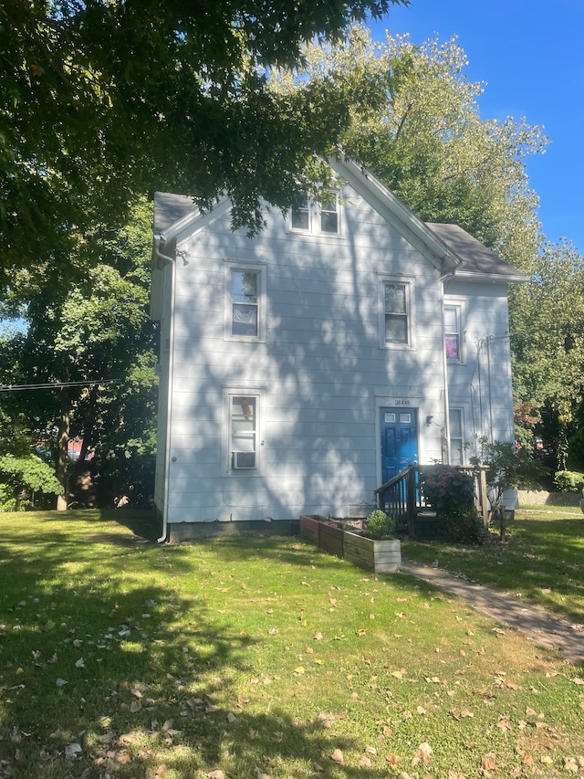 view of property exterior with a lawn