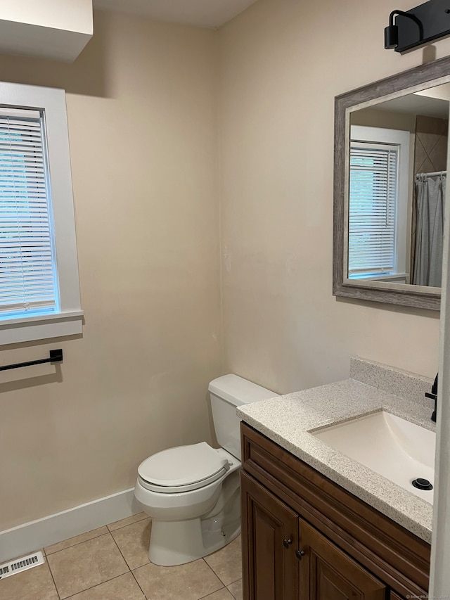 bathroom with tile patterned flooring, vanity, toilet, and a shower with curtain