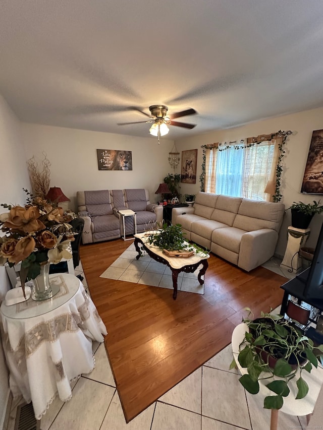 living room featuring ceiling fan and light hardwood / wood-style floors