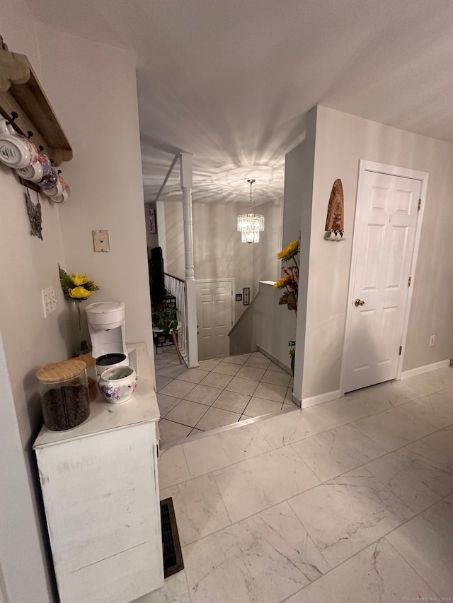 hallway featuring an inviting chandelier